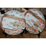 A pair of 19th century Japanese Imari porcelain plates with asymetric decoration of chrysanthemum,