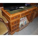 A reproduction twin pedestal desk with green leatherette top