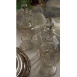 A pair of vintage hand painted glass decanters together with a similarly painted glass jar and