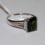 An Art Deco style 15ct white gold, green stone and diamond chip ring, gross weight 5.1 grams.