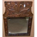 An early 20th century Arts & Crafts copper framed rectangular wall mirror, the hammered frame with