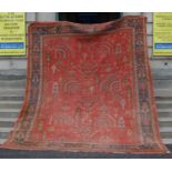 A late 19th/ early 20th century madder ground Ushak carpet, the abrashed madder ground decorated