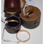 Three assorted yellow metal rings.