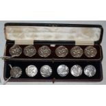 A cased set of six Birmingham silver Art Nouveau style buttons, chased with stylised flowers and
