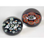 Two Paul Ysart paperweights, comprising a garland millefiori weight on a translucent mottled blue