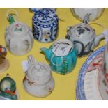 Five assorted Asian ceramic teapots.