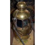 A vintage copper and brass lantern with clear and blue glass lens