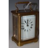 A late 19th/ early 20th century brass-cased carriage clock with black and white Roman numeral dial
