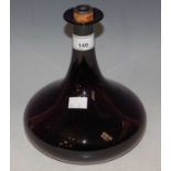 A 19th century purple glass decanter and cork stopper