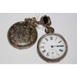 A vintage white metal open-faced pocket watch with black and white Roman numeral dial and subsidiary