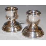 A pair of Birmingham silver candle stands.