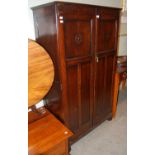 An early 20th century oak two-door compendium/ wardrobe.