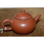 A Chinese Yixing teapot and cover, impressed rectangular seal mark, 7cm high.