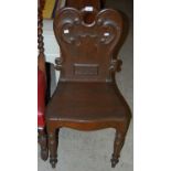 A Victorian oak hall chair, dated 1858, with scroll carved details