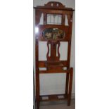 An early 20th century oak hall stand with leaded glass detail and bevelled mirror insert