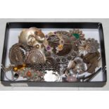 A collection of assorted white metal brooches.
