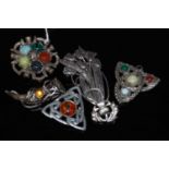 Five assorted Scottish white metal brooches, together with another white metal tulip-form brooch.