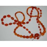 A vintage amber butterscotch graduated bead necklace, gross weight 39.8 grams, together with a peach