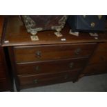 An oak chest of three long graduated drawers together with another dark wood chest of three long