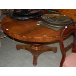 A 19th century rosewood snap-top supper table with circular hinged top on octagonal baluster