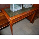 A reproduction yew wood side table with green leather top, three frieze drawers