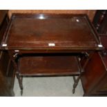 A vintage mahogany two-tier trolley with folding upper tier