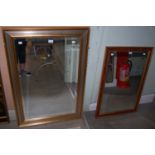 A rectangular bevelled wall mirror in gilded and silvered frame, together with another wood and