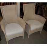 A pair of 20th century woven wicker conservatory armchairs with loose white upholstered cushion