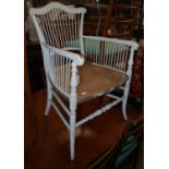 An early 20th century Arts & Crafts style white painted beechwood armchair with later solid wooden