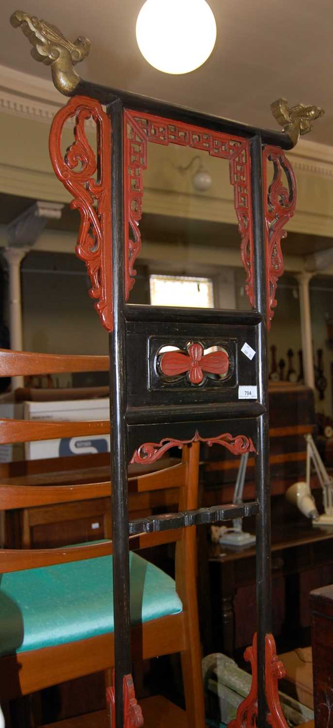 A Chinese carved and pierced wood hallstand with gilded, black and red painted details, 134cm high