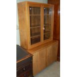 A mid 20th century mahogany two part bookcase, the upper section with glazed cupboard doors and