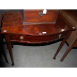 An early 20th century mahogany bowfront side table with single drawer on tapered cylindrical