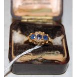 An 18ct gold sapphire and diamond chip ring, gross weight 2.1 grams