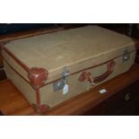 A vintage green canvas and faux brown leather travel case