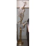 A brass and frosted glass three light standard lamp