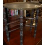 An early 20th century folding occasional table with circular brass top, together with a pair of
