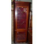 A 20th century mahogany two part corner cabinet with astragal glazed doors