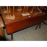A 19th century mahogany Pembroke table with single end drawer, turned supports, brass cups and