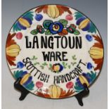 A hand-painted 'Langtoun Ware Scottish Handcraft' advertising pottery plate, 24.5cm diameter