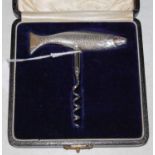 A Birmingham silver corkscrew fashioned in the form of a fish with simulated ruby inlaid eyes, gross