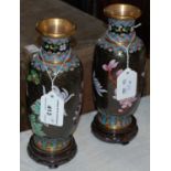 A pair of cloisonne vases, decorated with stylised flowers on hardwood stands