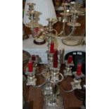 A pair of plated three-light candelabra together with another five-light candelabra with