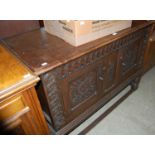 A late 19th / early 20th century stained oak side cabinet in the Jacobean style with two foliate