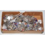 Twelve assorted white and enamel charm bracelets, the charms mainly inscribed 'silver', gross weight