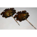 A pair of 19th century hand-painted papier maché handheld face fire screens, decorated with