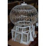 A vintage off-white painted birdcage in the form a hot air balloon