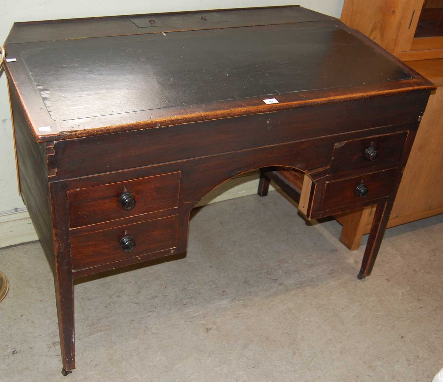 A 19th century stained pine estate desk with two detachable square-shaped covers revealing