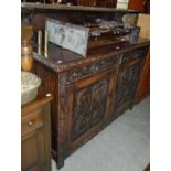 A Victorian stained oak sideboard with upright gallery shelf back, two frieze drawers and two