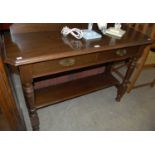 A dark wood console table with raised gallery back and two short drawers above a single shelf with