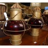 A pair of gilt metal and red glass ships hanging onion shaped oil burning lamps